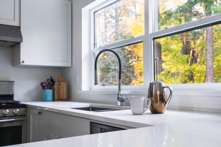 a kitchen with a sink, stove and a window