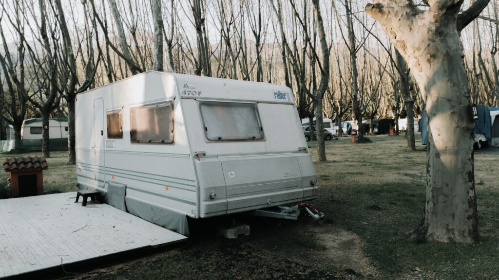 white rv trailer on gray concrete road during daytime