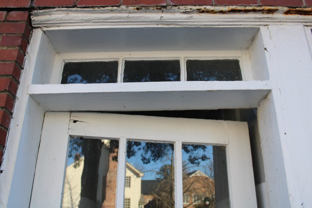 a close up of a window with a brick building in the background